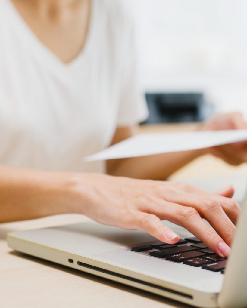 Freelance young Asia businesswoman casual wear using laptop working in living room at home. Working from home, remotely work, self isolation, social distancing, quarantine for corona virus prevention.